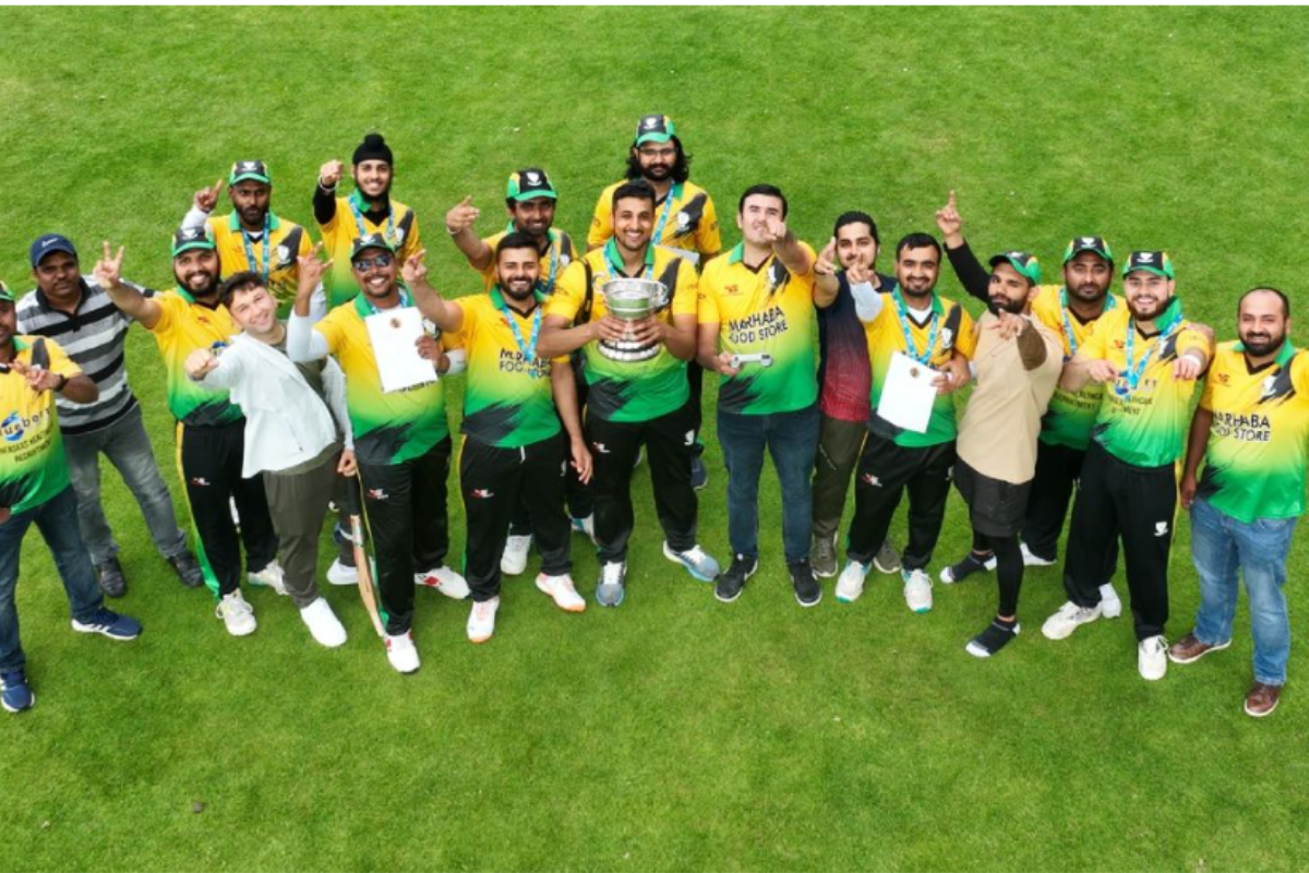Members of Dundalk Cricket Club posing together in team uniform