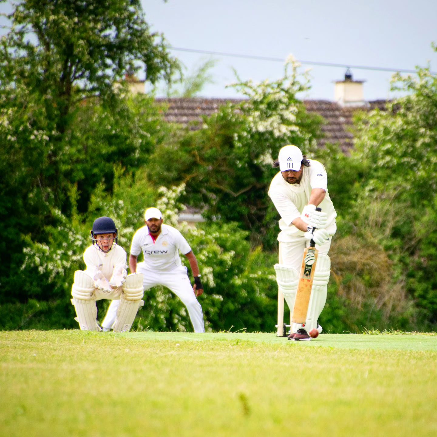 Dundalk Cricket Club team members in action during a match, demonstrating their cricketing skills on the field