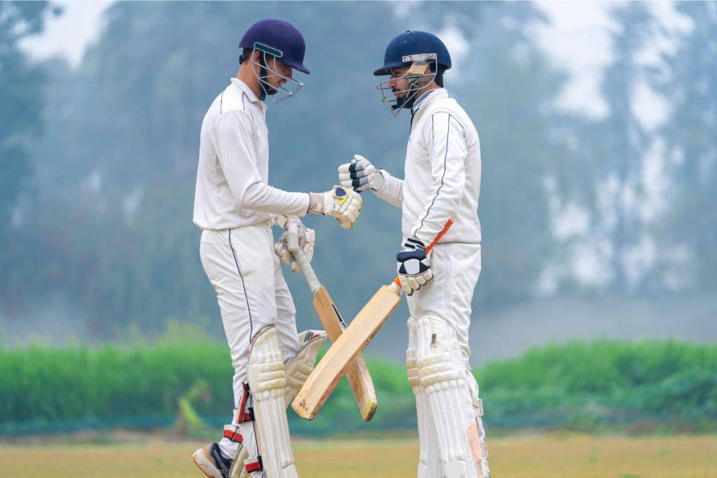 Dundalk Cricket Club team members in action during a match, demonstrating their cricketing skills on the field